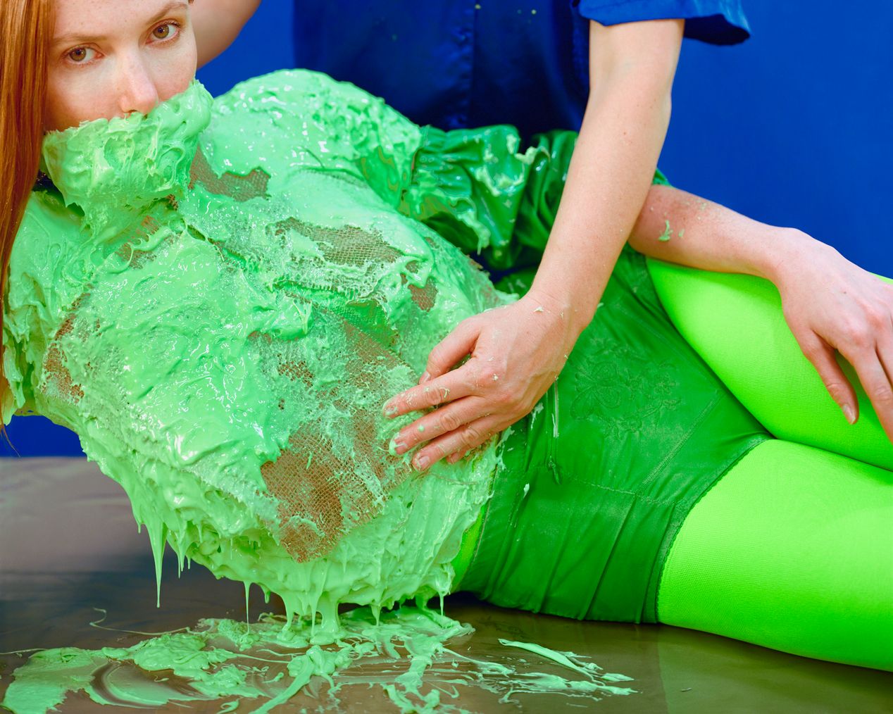 The artist is applying pieces of burlap to the green silicone cast, art photography, Ilona Szwarc, contemporary Los Angeles artist.