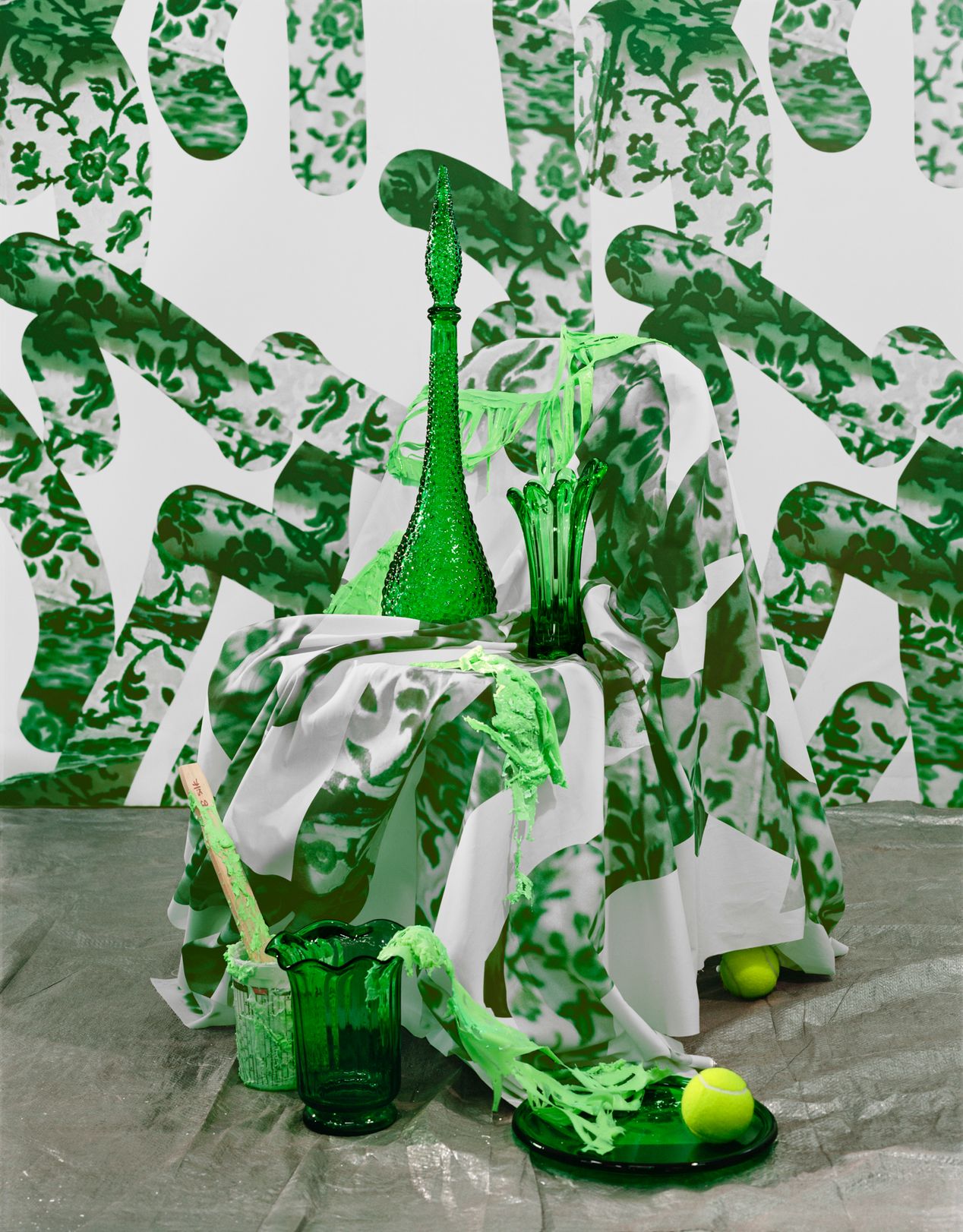 A still life with green glass vases and green patterned fabric and wallpaper, art photography, Ilona Szwarc, contemporary Los Angeles artist.