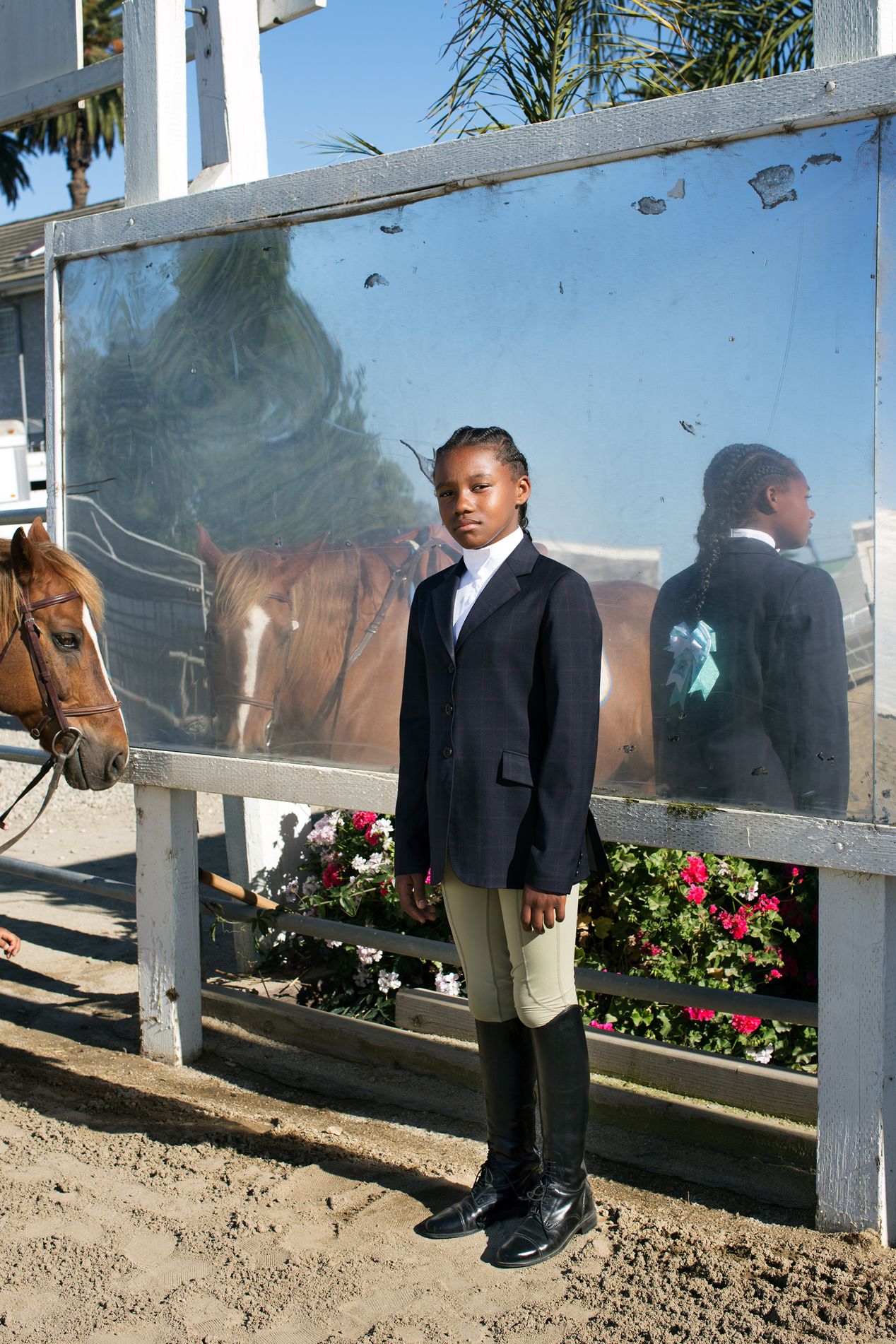 Young female equestrian at an arena, Ilona Szwarc, editorial photographer in Los Angeles. 
