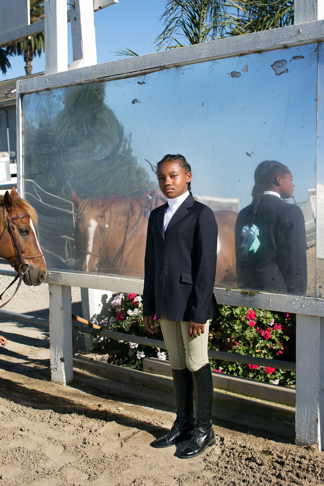 Young female equestrian at an arena, Ilona Szwarc, editorial photographer in Los Angeles.
