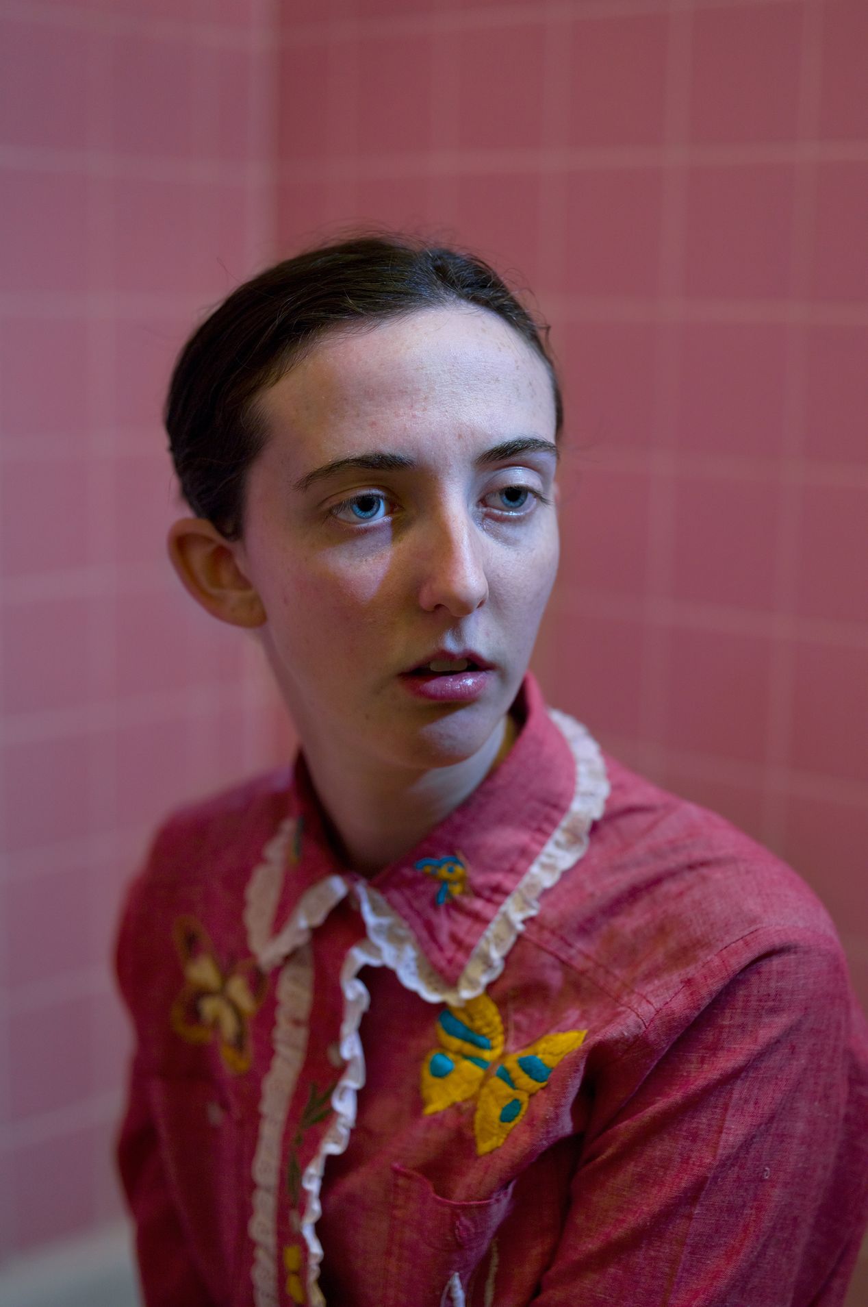 Closeup portrait of a woman in a pink bathroom, editorial photography, Ilona Szwarc, Los Angeles portrait photographer.