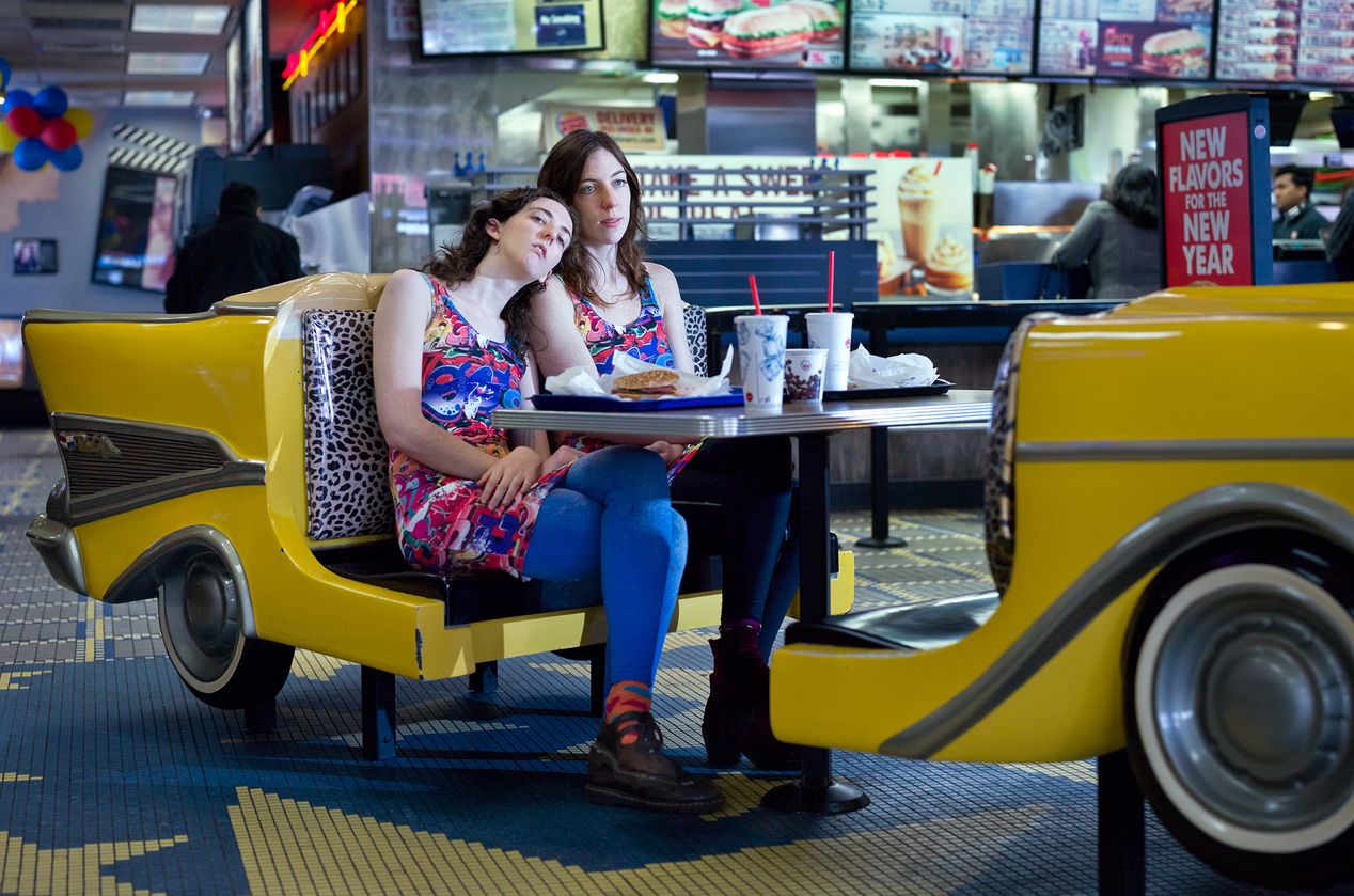 Two women sitting in a car shaped booth at a restaurant, editorial portrait photography, Ilona Szwarc, Los Angeles.