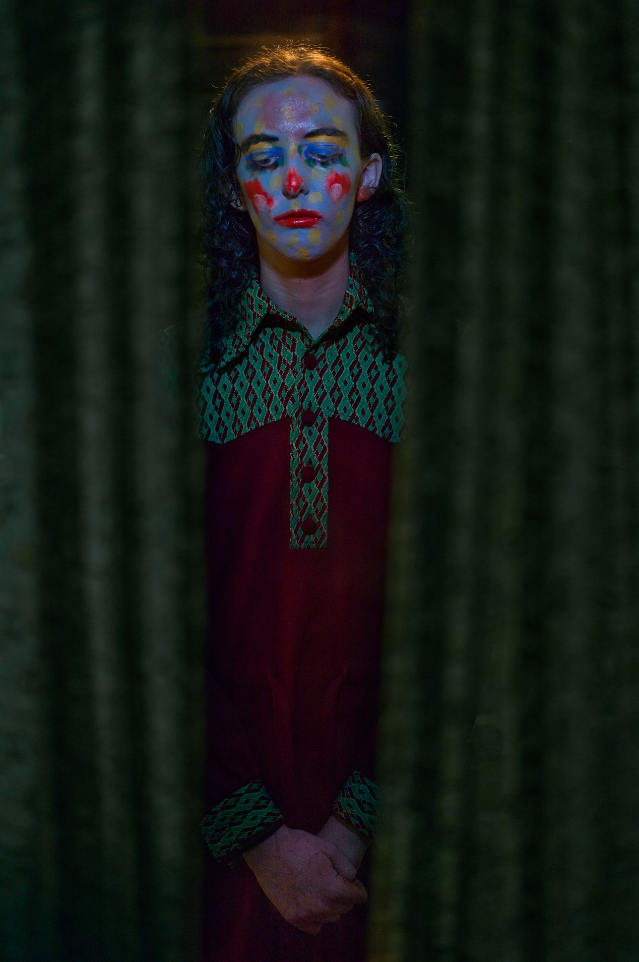Woman with painted face standing in a hallway, editorial photography, Ilona Szwarc, Los Angeles portrait photographer.