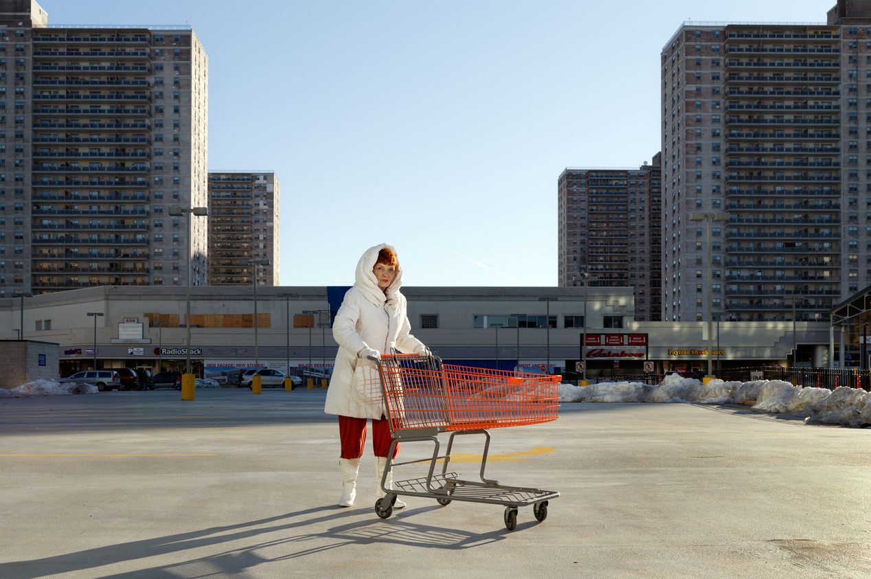 A woman pushing a shopping cart in a parking lot, editorial portrait photography, Ilona Szwarc, Los Angeles.