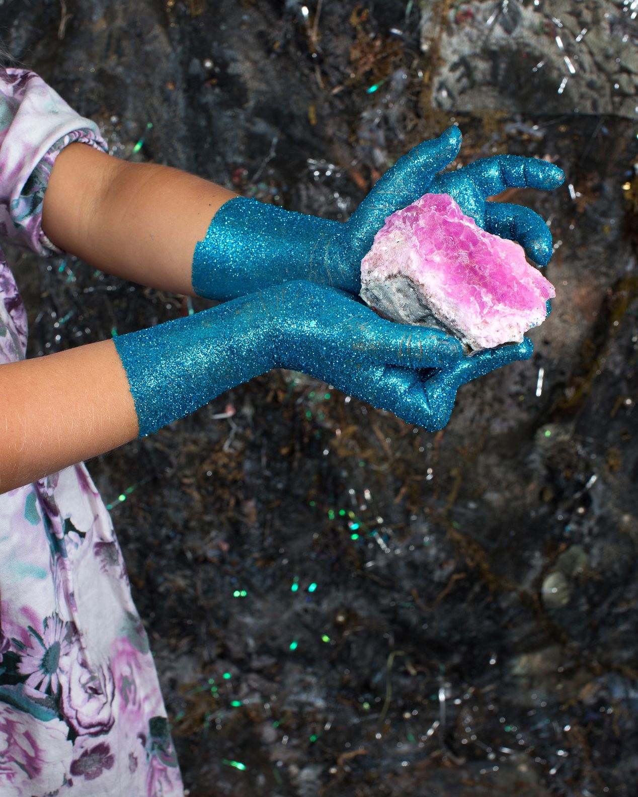 Detail photo of a girls hands covered in glitter, holding a large crystal, Ilona Szwarc, LA photo studio. 