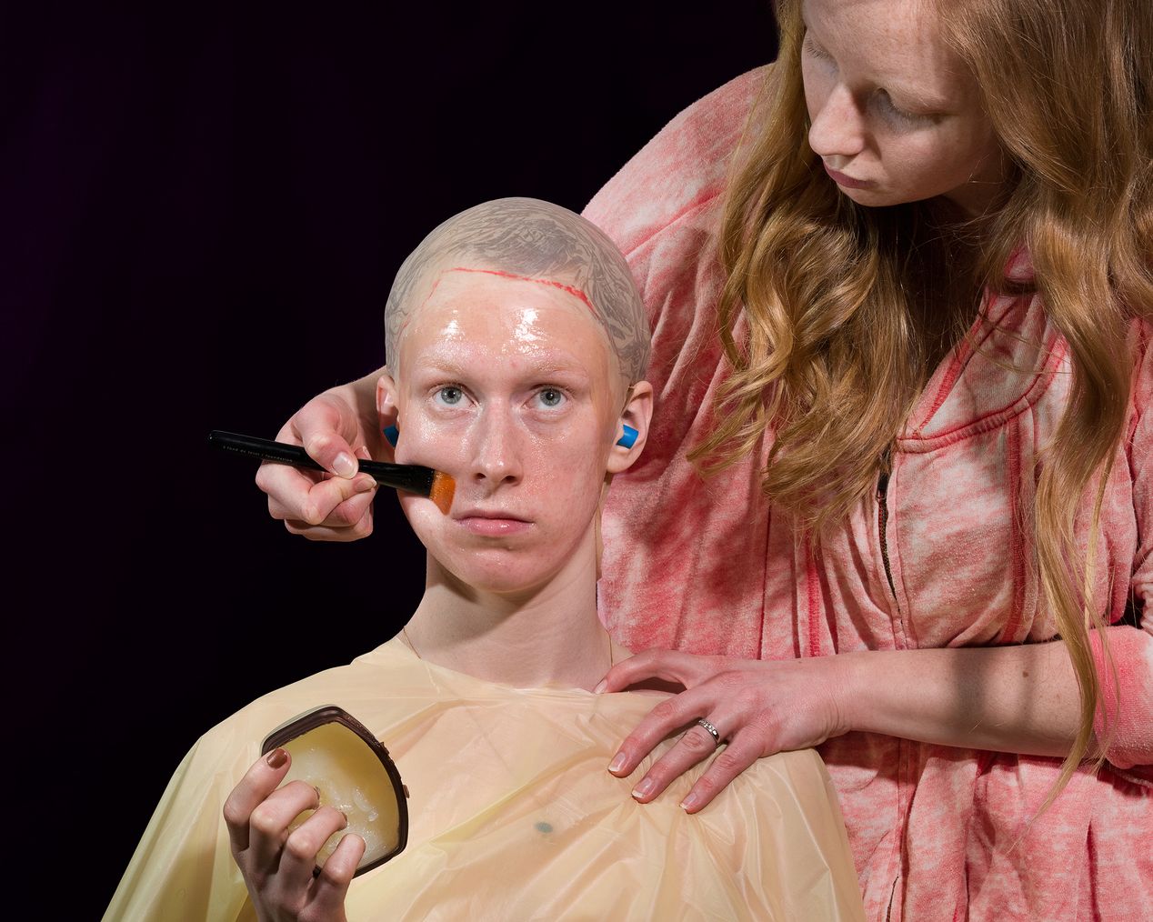 A woman is applying vaseline on a model's face, art photography, Ilona Szwarc, contemporary Los Angeles artist.