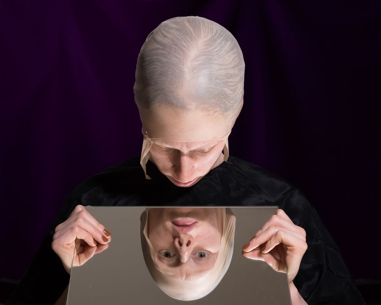 A woman in a bald cap looking at her mirror reflection, art photography, Ilona Szwarc, contemporary Los Angeles artist.