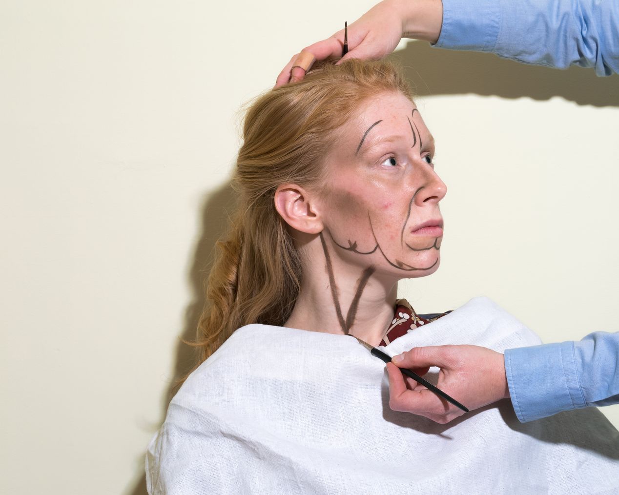 Makeup artist is painting large black lines on a model's neck, art photography, Ilona Szwarc, contemporary Los Angeles artist.