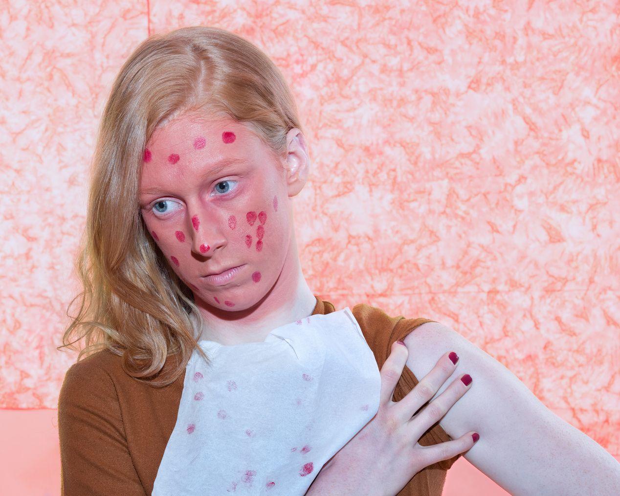Model's face is covered with pink paint and red dots, art photography, Ilona Szwarc, contemporary Los Angeles artist.