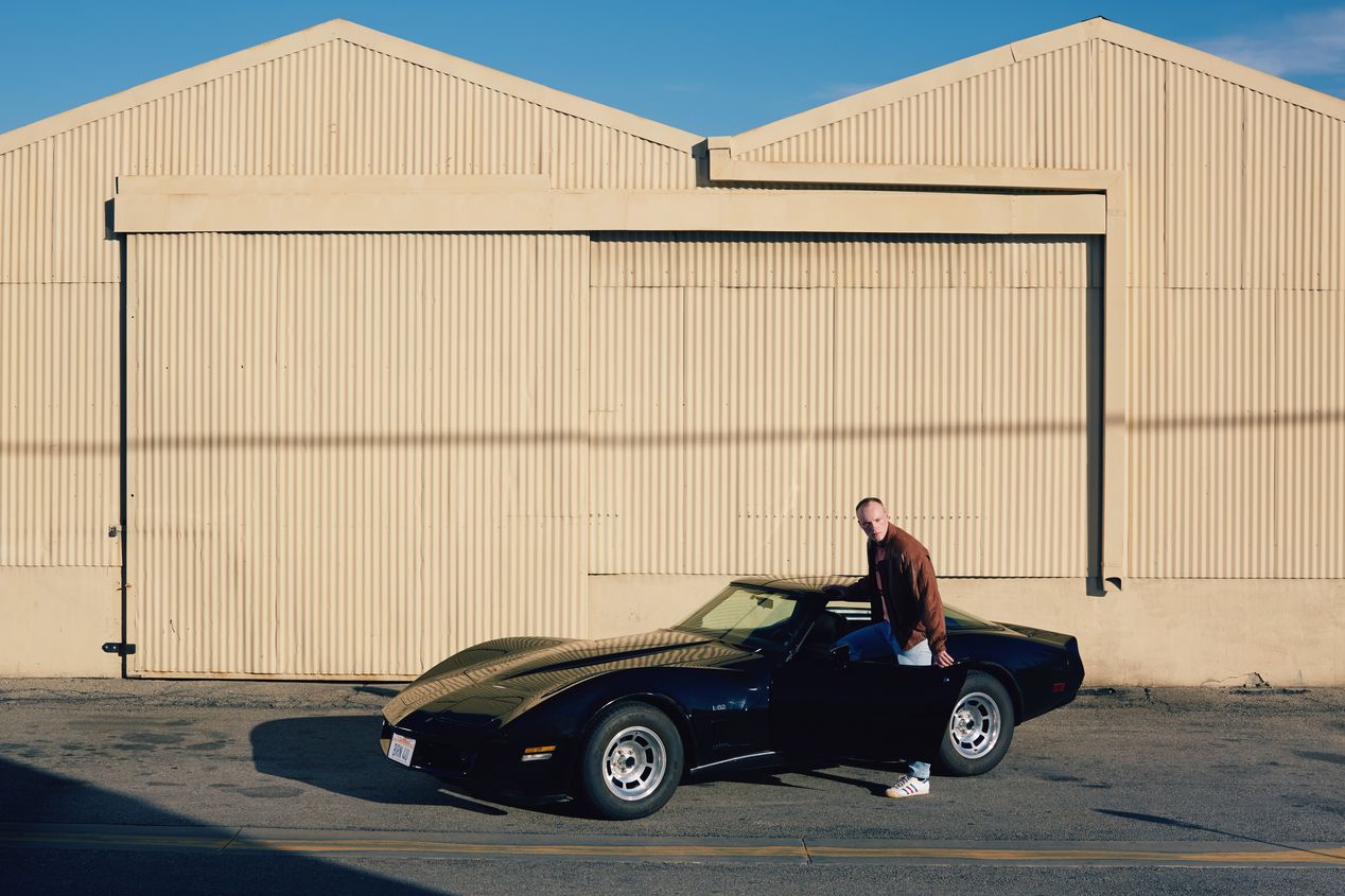 A man next to his black Corvette, Ilona Szwarc, Los Angeles editorial photographer.