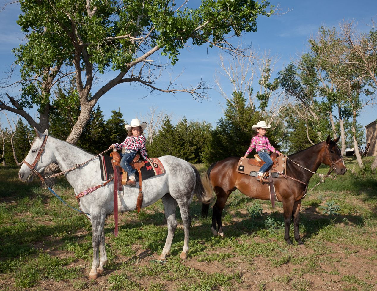Two young cowgirls on their horses, environmental portrait photography, Ilona Szwarc, contemporary Los Angeles artist.
