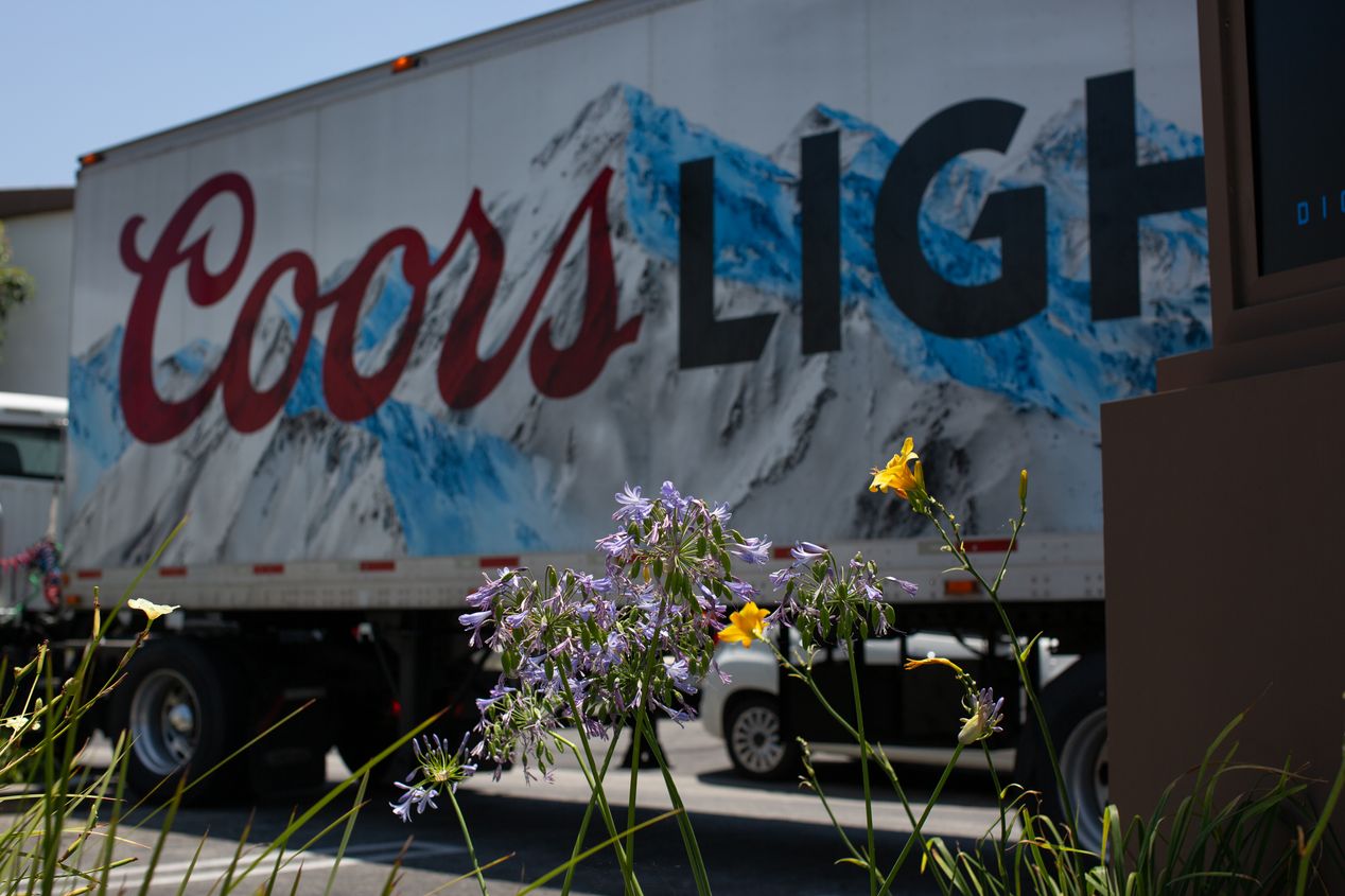 Blooming flowers in front of a Coors Light truck, editorial photography, Ilona Szwarc, Los Angeles.