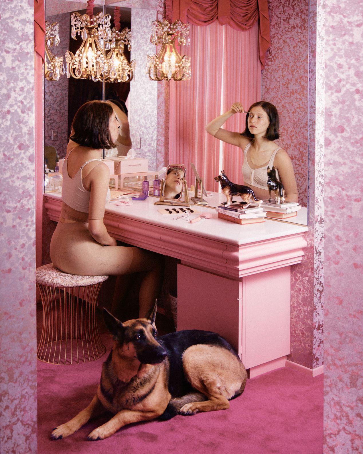 A young woman and her dog at her vanity applying makeup, art photography, Ilona Szwarc, contemporary Los Angeles artist.