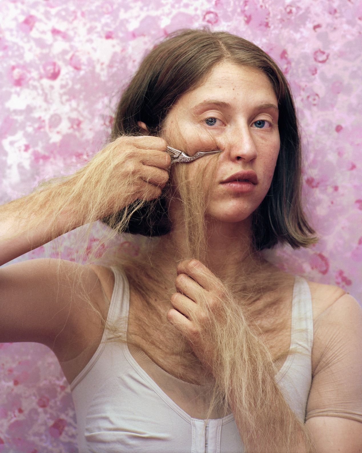 A young woman applying hair to her cheeks, art photography, Ilona Szwarc, contemporary Los Angeles artist.